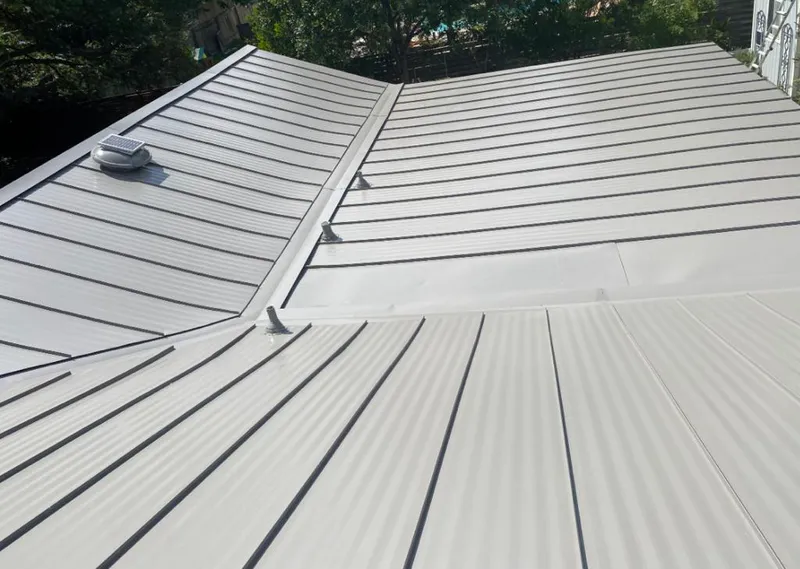 Solar attic fan installed on a metal roof for Roof Ventilation in Boylston